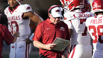 Nov 22, 2025; Austin, Texas, USA; Arkansas Razorbacks interim head coach Bobby Petrino looks at his notes during the first half against the Texas Longhorns at Darrell K Royal-Texas Memorial Stadium. Mandatory Credit: Scott Wachter-Imagn Images