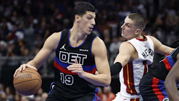 Nov 12, 2024; Detroit, Michigan, USA;  Detroit Pistons forward Simone Fontecchio (19) dribbles defended by Miami Heat guard Tyler Herro (14) in the second half at Little Caesars Arena. Mandatory Credit: Rick Osentoski-Imagn Images