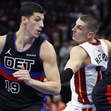Nov 12, 2024; Detroit, Michigan, USA;  Detroit Pistons forward Simone Fontecchio (19) dribbles defended by Miami Heat guard Tyler Herro (14) in the second half at Little Caesars Arena. Mandatory Credit: Rick Osentoski-Imagn Images