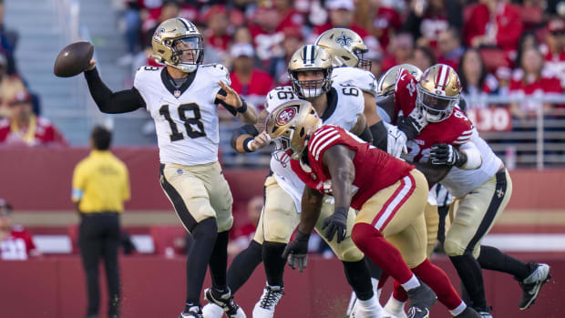 New Orleans Saints quarterback Spencer Rattler (18) throws under pressure against the San Francisco 49ers