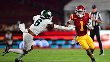 Sep 20, 2025; Los Angeles, California, USA; Southern California Trojans running back Eli Sanders (1) runs the ball ahead of Michigan State Spartans defensive back Ade Willie (6) during the first half at the Los Angeles Memorial Coliseum. Mandatory Credit: Gary A. Vasquez-Imagn Images
