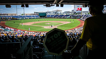 An usher holds a sign stopping fans from walking down the aisle during the championship game of the Big Ten Baseball Tournament between Iowa and Maryland, Sunday, May 28, 2023, at Charles Schwab Field in Omaha, Neb.