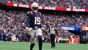 Jan 5, 2025; Foxborough, Massachusetts, USA; New England Patriots quarterback Joe Milton III (19) runs the ball for a touchdown against the Buffalo Bills in the first quarter at Gillette Stadium. Mandatory Credit: David Butler II-Imagn Images