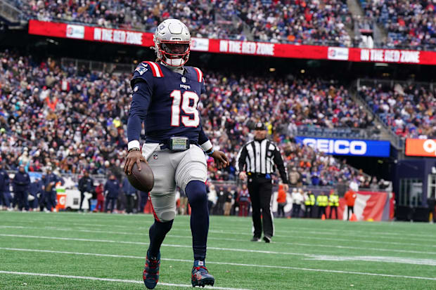 New England Patriots quarterback Joe Milton III  runs the ball for a touchdown against the Buffalo Bills