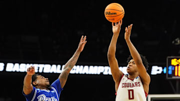 Mar 21, 2024; Omaha, NE, USA; Washington State Cougars forward Jaylen Wells (0) shoots against Drake Bulldogs guard Atin Wright (10) in the second half in the first round of the 2024 NCAA Tournament at CHI Health Center Omaha. Mandatory Credit: Dylan Widger-USA TODAY Sports