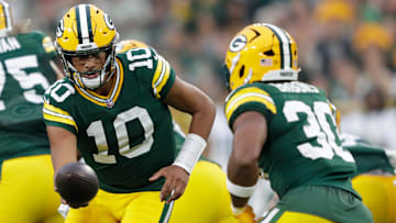 Green Bay Packers quarterback Jordan Love (10) hands off the ball to running back Chris Brooks (30) against the Jets during their football game Saturday, August 9, 2025, at Lambeau Field in Green Bay, Wisconsin.