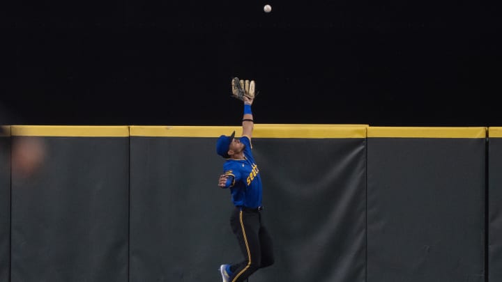 Seattle Mariners center fielder Julio Rodriguez attempts to catch a ball at the wall during a game against the San Francisco Giants on Friday.