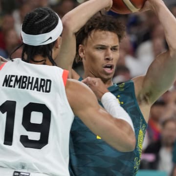 Jul 30, 2024; Villeneuve-d'Ascq, France; Australia point guard Dyson Daniels (1) in action against Canada point guard Andrew Nembhard (19) in a men's group stage basketball match during the Paris 2024 Olympic Summer Games at Stade Pierre-Mauroy. Mandatory Credit: John David Mercer-USA TODAY Sports