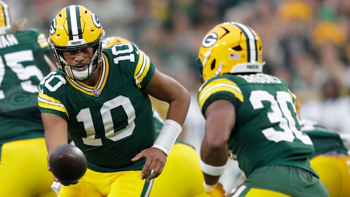 Green Bay Packers quarterback Jordan Love hands off the ball to running back Chris Brooks against the Jets during their game 