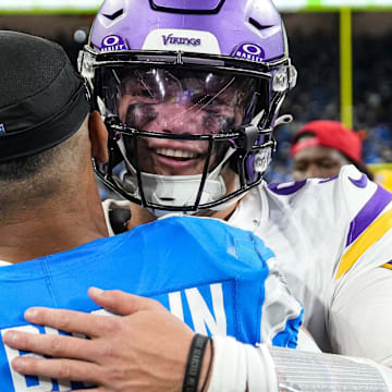 Minnesota Vikings quarterback J.J. McCarthy (9 hugs Detroit Lions wide receiver Amon-Ra St. Brown (14) 
