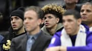 Dec 14, 2017; Cleveland, OH, USA;  LiAngelo Ball, back left, and LaMelo Ball sit behind their brother, Los Angeles Lakers guard Lonzo Ball, front right, during a game between the Cleveland Cavaliers and the Los Angeles Lakers at Quicken Loans Arena. Mandatory Credit: David Richard-Imagn Images