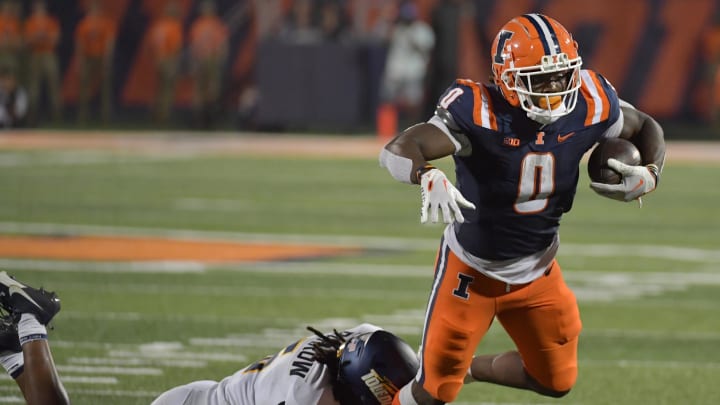 Sep 2, 2023; Champaign, Illinois, USA;  Illinois Fighting Illini running back Josh McCray (0) is tackled by Toledo Rockets linebacker Jackson Barrow (5) during the second half at Memorial Stadium. Mandatory Credit: Ron Johnson-USA TODAY Sports