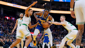 Dec 10, 2022; San Francisco, California, USA; Golden State Warriors forward Jonathan Kuminga (00) controls the ball against Boston Celtics guard Malcolm Brogdon (13) and forward Sam Hauser (30) in the third quarter at the Chase Center. Mandatory Credit: Cary Edmondson-Imagn Images
