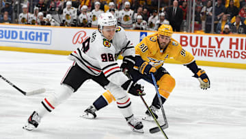 Jan 2, 2024; Nashville, Tennessee, USA; Chicago Blackhawks center Connor Bedard (98) handles the puck against Nashville Predators center Ryan O'Reilly (90) during the second period at Bridgestone Arena. Mandatory Credit: Christopher Hanewinckel-Imagn Images