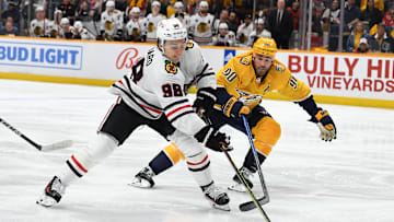Jan 2, 2024; Nashville, Tennessee, USA; Chicago Blackhawks center Connor Bedard (98) handles the puck against Nashville Predators center Ryan O'Reilly (90) during the second period at Bridgestone Arena. Mandatory Credit: Christopher Hanewinckel-Imagn Images