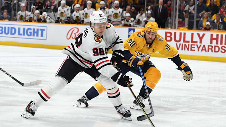 Jan 2, 2024; Nashville, Tennessee, USA; Chicago Blackhawks center Connor Bedard (98) handles the puck against Nashville Predators center Ryan O'Reilly (90) during the second period at Bridgestone Arena. Mandatory Credit: Christopher Hanewinckel-Imagn Images
