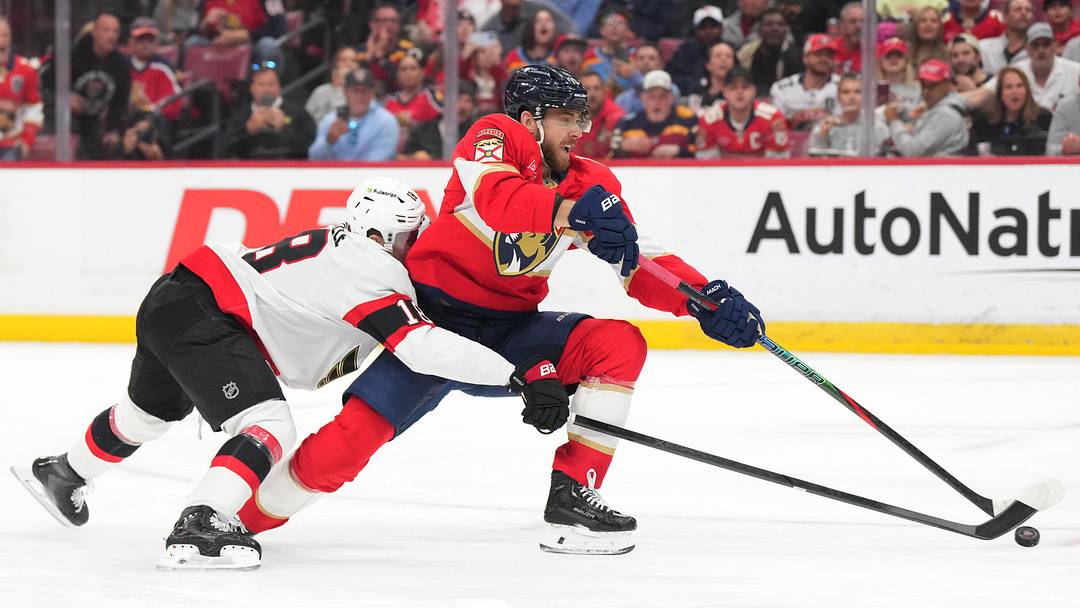 Mar 31, 2026; Sunrise, Florida, USA;  Florida Panthers left wing A.J. Greer (10) takes a short-handed shot on goal as Ottawa Senators center Tim Stutzle (18) defends during the second period at Amerant Bank Arena. Mandatory Credit: Jim Rassol-Imagn Images