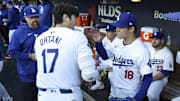 Oct 5, 2024; Los Angeles, California, USA; Los Angeles Dodgers designated hitter Shohei Ohtani (17) and pitcher Yoshinobu Yamamoto (18) interact before playing the San Diego Padres during game one of the NLDS for the 2024 MLB Playoffs at Dodger Stadium. 