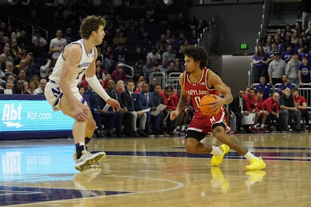 Northwestern Wildcats forward Nick Martinelli (2) defends Maryland Terrapins guard Donald Carey (0).