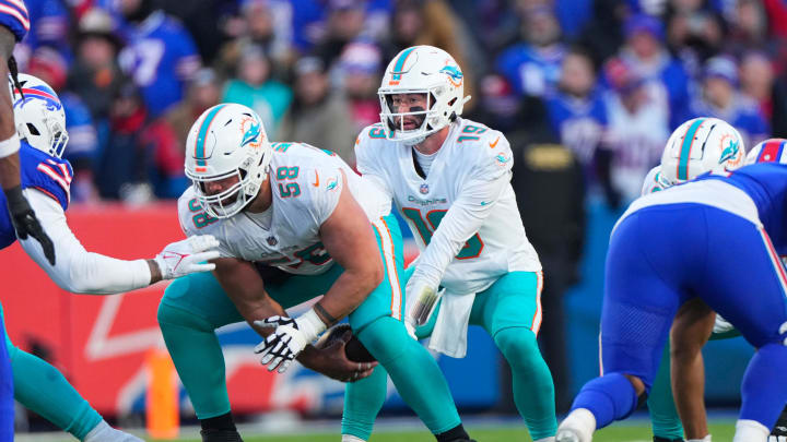 Jan 15, 2023; Orchard Park, New York, USA; Miami Dolphins guard Connor Williams (58) snaps the ball to Miami Dolphins quarterback Skylar Thompson (19) during a wild card game against the Buffalo Bills at Highmark Stadium. Mandatory Credit: Gregory Fisher-USA TODAY Sports