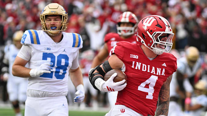 Oct 25, 2025; Bloomington, Indiana, USA; Indiana Hoosiers linebacker Aiden Fisher (4) returns an interception for a touchdown during the first half against the UCLA Bruins at Memorial Stadium. Mandatory Credit: Robert Goddin-Imagn Images