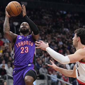 Apr 3, 2025; Toronto, Ontario, CAN; Toronto Raptors guard Jamal Shead (23) goes up to make a basket against Portland Trail Blazers forward Deni Avdija (8) during the first half at Scotiabank Arena. Mandatory Credit: John E. Sokolowski-Imagn Images