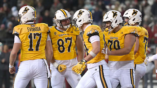 Wyoming Cowboys tight end John Michael Gyllenborg (84) celebrates the game winning touchdown with his team against the Washin