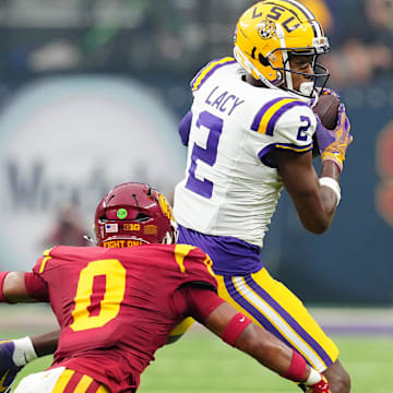 Sep 1, 2024; Paradise, Nevada, USA; LSU Tigers wide receiver Kyren Lacy (2) makes a catch in front of Southern California Trojans safety Akili Arnold (0) during the first quarter at Allegiant Stadium. Mandatory Credit: Stephen R. Sylvanie-USA TODAY Sports