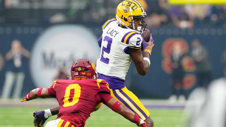 Sep 1, 2024; Paradise, Nevada, USA; LSU Tigers wide receiver Kyren Lacy (2) makes a catch in front of Southern California Trojans safety Akili Arnold (0) during the first quarter at Allegiant Stadium. Mandatory Credit: Stephen R. Sylvanie-USA TODAY Sports