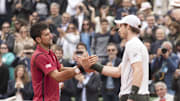 Novak Djokovic and Andy Murray shake hands at the net after their match at the 2016 French Open. 