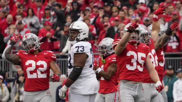 Oct 21, 2023; Columbus, Ohio, USA; Ohio State Buckeyes linebacker Steele Chambers (22), linebacker Tommy Eichenberg (35) and teammates celebrate a false start by Penn State Nittany Lions offensive lineman Caedan Wallace (73) during the NCAA football game at Ohio Stadium.