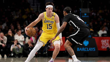 Mar 10, 2025; Brooklyn, New York, USA; Los Angeles Lakers guard Austin Reaves (15) controls the ball against Brooklyn Nets guard Keon Johnson (45) during the first quarter at Barclays Center. Mandatory Credit: Brad Penner-Imagn Images