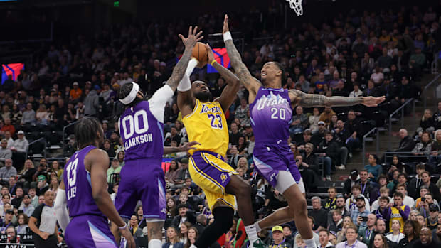 Utah Jazz guard Jordan Clarkson (00) and forward John Collins (20) keep Los Angeles Lakers forward LeBron James