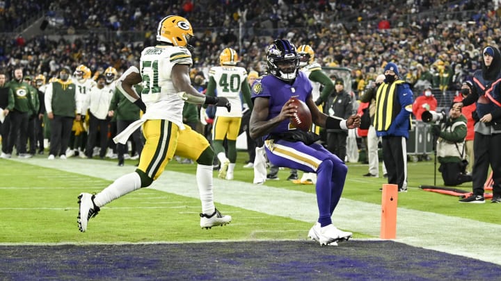 Dec 19, 2021; Baltimore, Maryland, USA; Baltimore Ravens quarterback Tyler Huntley (2) score a touchdown  in front of Green Bay Packers inside linebacker Krys Barnes (51)  during the second half at M&T Bank Stadium. Mandatory Credit: Tommy Gilligan-USA TODAY Sports