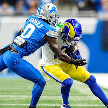 Detroit Lions cornerback Terrion Arnold (0) tackles Los Angeles Rams wide receiver Cooper Kupp (10) 