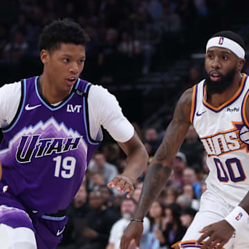 Oct 27, 2025; Salt Lake City, Utah, USA; Utah Jazz guard Ace Bailey (19) drives against Phoenix Suns forward Royce O'Neale (00) during the second half at Delta Center. Mandatory Credit: Rob Gray-Imagn Images