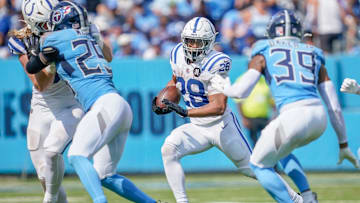 Indianapolis Colts running back Jonathan Taylor (28) runs through the Tennessee Titans defense during the third quarter at Nissan Stadium in Nashville, Tenn., Sunday, Sept. 21, 2025.