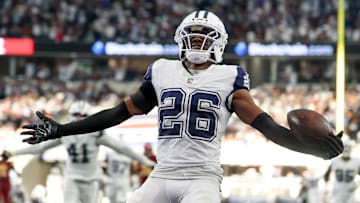 Oct 19, 2025; Arlington, Texas, USA; Dallas Cowboys cornerback Daron Bland (26) carries the ball after an interception for a touchdown against the Washington Commanders during the third quarter of the game at AT&T Stadium. Mandatory Credit: Kevin Jairaj-Imagn Images