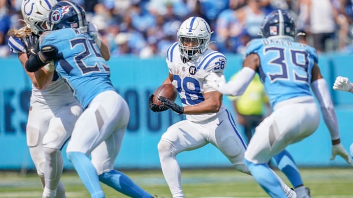Indianapolis Colts running back Jonathan Taylor (28) runs through the Tennessee Titans defense during the third quarter at Nissan Stadium in Nashville, Tenn., Sunday, Sept. 21, 2025.