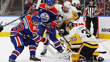 Edmonton Oilers forward Victor Arvidsson (33) jams at a loose puck in front of Pittsburgh Penguins goaltender