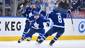 Apr 22, 2025; Toronto, Ontario, CAN;  Toronto Maple Leafs forward Max Domi (11) celebrates with defenseman Chris Tanev (8) and forward Auston Matthews (34) after scoring the winning goal in overtime against the Ottawa Senators in game two of the first round of the 2025 Stanley Cup Playoffs at Scotiabank Arena. Mandatory Credit: Dan Hamilton-Imagn Images