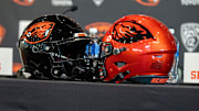 Oregon State football helmets sit on a table before the introductory press conference of the hiring of its new head football coach, JaMarcus Shephard, at Reser Stadium on Tuesday, Dec. 2, 2025, in Corvallis, Ore.