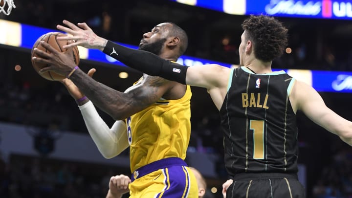 Jan 2, 2023; Charlotte, North Carolina, USA; Los Angeles Lakers forward LeBron James (6) drives in as he is defended by Charlotte Hornets guard LaMelo Ball (1) during second half at the Spectrum Center. Mandatory Credit: Sam Sharpe-USA TODAY Sports