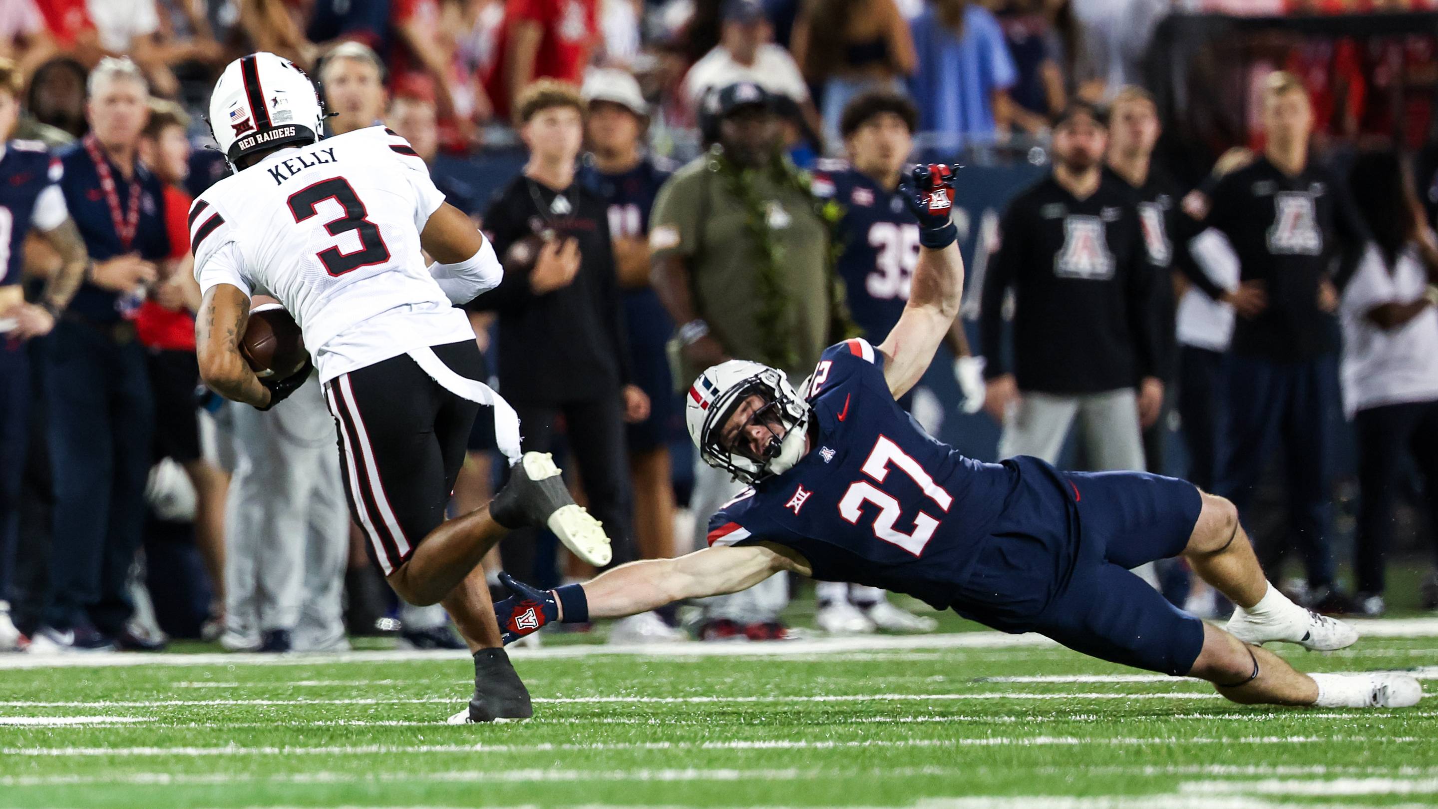 Arizona Wildcats defensive back fails to tackle Texas Tech Red Raiders wild receiver. Mandatory Credit: Aryanna Frank-Imagn Images | USA TODAY Sports via Reuters Connect