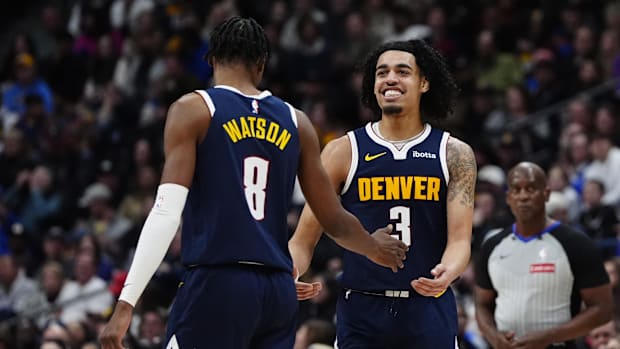 Dec 28, 2024; Denver, Colorado, USA; Denver Nuggets guard Julian Strawther (3) reacts to his basket scored with forward Peyto