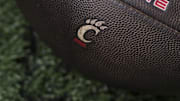 Sep 6, 2025; Cincinnati, Ohio, USA; The Cincinnati logo is seen on a football before the game between the Bowling Green Falcons and the Cincinnati Bearcats at Nippert Stadium. Mandatory Credit: Aaron Doster-Imagn Images