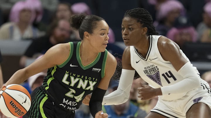 Sep 11, 2025; Minneapolis, Minnesota, USA; Minnesota Lynx forward Napheesa Collier (24) dribbles against Golden State Valkyries center Temi Fagbenle (14) in the first half at Target Center. Mandatory Credit: Jesse Johnson-Imagn Images