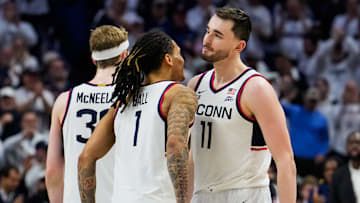 Solo Ball #1 and Alex Karaban #11 react during the second half of an NCAA basketball game at the Harry A. Gampel Pavilion on March 5, 2025 in Storrs, Connecticut