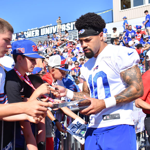 Khalil Shakir (10) signs an autograph