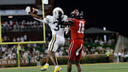Nov 15, 2025; Waco, Texas, USA; Baylor Bears wide receiver Josh Cameron (34) makes a catch against Utah Utes cornerback Blake Cotton (16) during the second half at McLane Stadium. Mandatory Credit: Chris Jones-Imagn Images